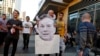 A Los Angeles Clippers fan holds a cut out picture of owner Donald Sterling as the fan arrives to attend the Clippers playoff game five against the Golden State Warriors at the Staples Center in Los Angeles, California, April 29, 2014.