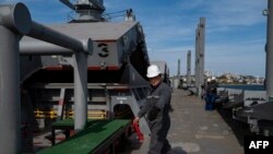FILE - A U.N. official inspects the Barbados-flagged ship Nord Vind coming from Ukraine loaded with grain and anchored in Istanbul, on Oct. 11, 2022.