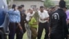 Pakistani police officials escort a young Christian girl accused of blasphemy for allegedly burning pages of a Quran, toward a helicopter following her release from central prison on the outskirts of Rawalpindi, September 8, 2012.