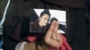 FILE - Renu, eldest sister of Shamima Begum, who had gone missing at the time, holds up a picture of her while being interviewed by the media in London, Britain, Feb. 22, 2015.