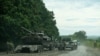 Tentara Ukraina memeriksa kendaraan militer Rusia yang ditinggalkan di sebuah trailer selama pertempuran di Kharkif, Ukraina Minggu 11 September 2022.