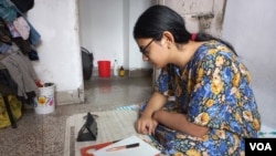FILE - A high school student attends an online class using a smartphone during a COVID-19 lockdown in 2021. (Shaikh Azizur Rahman/VOA)