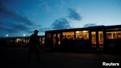 FILE - Service members of Ukrainian forces who have surrendered after weeks holed up at Azovstal steel works are seen inside a bus, which arrived under escort of the pro-Russian military, at a detention facility in the Donetsk Region, Ukraine, May 17, 2022. 