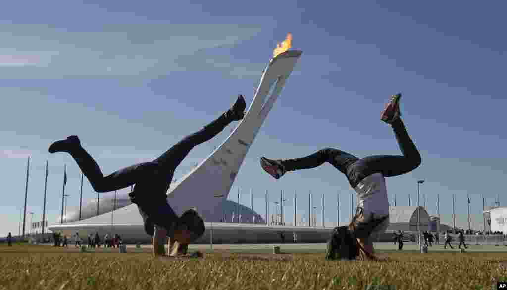 Young girls play on a warm day in the Olympic Plaza, Sochi, Russia, Feb. 12, 2014.