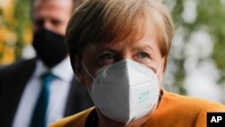 German Chancellor Angela Merkel arrives about a news conference German Government's corona policy in Berlin, Germany, Monday, Nov. 2, 2020. (AP Photo/Markus Schreiber)
