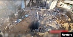 An opening to a tunnel that, according to Israel's military, was used by Palestinian militants under Al Shifa hospital in the Gaza Strip as seen in this screen grab taken from a handout video released by the Israel Defense Forces, Nov. 19, 2023.
