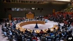 People gather during the Security Council meeting at United Nations headquarters, Dec. 22, 2023. After many delays, the U.N. Security Council adopted a watered-down resolution Friday calling for immediately speeding up aid deliveries to civilians in Gaza.