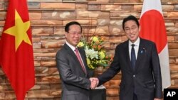 Vietnam's President Vo Van Thuong, left, and Japan's Prime Minister Fumio Kishida shake hands during their meeting at the prime minister's official residence in Tokyo, Japan, Nov. 27, 2023.