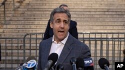 FILE - Michael Cohen speaks to members of media as he arrives for former President Donald Trump's civil business fraud trial at New York Supreme Court, Oct. 24, 2023.