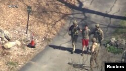 FBI agents arrest Jack Teixeira, an employee of the U.S. Air Force National Guard, outside a residence in this still image taken from video in Dighton, Massachusetts, April 13, 2023. (WCVB-TV via ABC via Reuters)