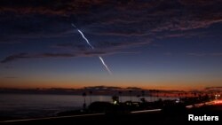 FILE: An evening launch of a SpaceX Falcon 9 rocket carrying 20 Starlink V2 Mini satellites, from Space Launch Complex at Vandenberg Space Force Base is seen over the Pacific Ocean from Encinitas, California, June 23, 2024. 