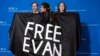 Wall Street Journal journalist Vivian Salama displays a cape with the name of her colleague WSJ correspondent Evan Gershkovich, who is detained in Russia, at the annual White House Correspondents' Association Dinner in Washington, April 29, 2023. 