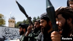 Taliban soldiers celebrate on the second anniversary of the fall of Kabul on a street in Kabul, Afghanistan, Aug. 15, 2023.