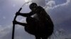 FILE - A man bathes in a village on the outskirts of Ajmer during the longest heat wave ever to hit India, June 11, 2024. The government's top weather expert had warned people that they would face increasingly oppressive temperatures. 