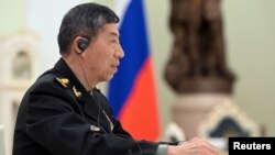 FILE - Chinese Defense Minister Li Shangfu attends a meeting with Russian President Vladimir Putin and Defense Minister Sergei Shoigu in Moscow, April 16, 2023. (Sputnik/Pavel Bednyakov/Pool via Reuters.)