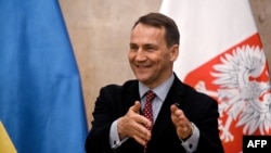 Polish Foreign Minister Radoslaw Sikorski speaks to reporters during his visit in Kyiv, Dec. 22, 2023.