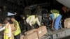 People move boxes after an Indian Air Force flight landed with medical aid, following the crisis in Sudan's capital Khartoum, at the military airport of Port Sudan, Sudan, May 18, 2023. 