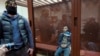 Далерџон Мирзоев, осомничен за пукањето во концертна сала во Русија, седи во стаклен кафез во Окружниот суд Басмани во Москва, Русија, 24 март 2024 година.