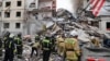 This photo released by Belgorod regional Governor Vyacheslav Gladkov on social media May 12, 2024, shows Russian emergency workers outside a partly collapsed block of flats after a Ukrainian missile attack, in Belgorod city. 