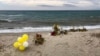 Flowers are left where the wreckage of a capsized boat washed ashore at a beach near Cutro, southern Italy, March 9, 2023. More than 70 people died in a recent shipwreck on Italy's Calabrian coast. 