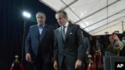 Mohammad Eslami, who heads the Atomic Energy Organization of Iran, left, and Rafael Mariano Grossi, who heads the International Atomic Energy Organization, arrive for a joint press conference in Tehran, Iran, March 4, 2023.