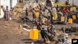 FILE - People displaced by fighting between Congolese forces and M23 rebels gather in a camp on the outskirts of Goma, Democratic Republic of the Congo, March 13, 2024.
