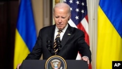 President Joe Biden attends a news conference with Ukrainian President Volodymyr Zelenskyy in the Indian Treaty Room in the Eisenhower Executive Office Building on the White House Campus, Dec. 12, 2023. 