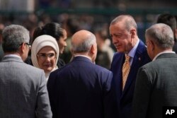 Turkish President and leader of the Justice and Development Party, or AKP, Recep Tayyip Erdogan, right, arrives to vote to a polling station in Istanbul, Turkey, March 31, 2024.