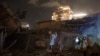 FILE - People inspect the damage from a rocket fired from the Gaza Strip, in Tel Aviv, Israel, Oct. 7, 2023.