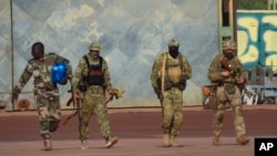 This undated photograph provided by the French military shows three Russian mercenaries in northern Mali.