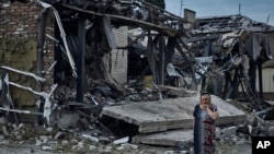 A woman reacts at the scene of a building damaged after recent Russian missile strikes in Pokrovsk, Donetsk region, Ukraine, Aug. 9, 2023.