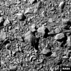 FILE - An image of asteroid moonlet Dimorphos, taken on NASA's DART mission 12 kilometers from the asteroid and 2 seconds before impact, released Sept. 26, 2022. (NASA/Johns Hopkins APL/Reuters)