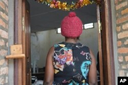 A 39-year-old security guard stands on the doorway at a clinic in Bangui, Central African Republic, March 11, 2024. She said she was sexually assaulted by a U.N. peacekeeper in November while on the night shift.