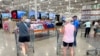 Shoppers push carts into a Costco warehouse, Aug. 4, 2023, in Thornton, Colorado.