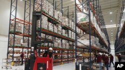 FILE - Workers unpack medicine at a "mega-pharmacy" warehouse on its inauguration day in Huehuetoca, Mexico, Dec. 29, 2023. 