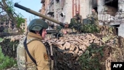 FILE - This image taken from footage posted May 25, 2023, on the Telegram account of the press service of Concord, a company linked to Wagner Group chief Yevgeny Prigozhin, shows Prigozhin talking to some of his fighters in Bakhmut.