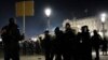 A protester faces police officers at Concorde square after a demonstration in Paris, March 16, 2023.