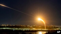 FILE - Ukrainian air defense intercepts a Shahed drone midair in a Russian aerial attack on Kyiv, Ukraine, May 30, 2023.