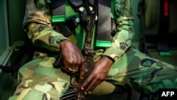 FILE - A U.N. peacekeeper holds his weapon while on patrol in Paoua, Central African Republic, Dec. 5, 2021. An unidentified armed group attacked one of the peacekeeping patrols on Monday, killing a peacekeeper from Rwanda, the U.N. said. 