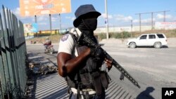 A National Police officer patrols an intersection in Port-au-Prince, Haiti, Jan. 26, 2024.