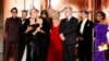 Producer Emma Thomas accepts the award for best motion picture drama for "Oppenheimer" as cast and crew members, from left, Robert Downey Jr., Matt Damon, Ludwig Göransson, Florence Pugh, Christopher Nolan, Cillian Murphy and presenter Oprah Winfrey look on. (CBS via AP)