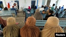 FILE - Afghan female refugees living in Pakistan wait to get registered at an office in Peshawar, Pakistan, Sept. 30, 2021. Pakistan confirmed Sept. 28, 2023, that all foreign nationals living unlawfully in the country would be forced out.
