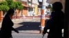 A police officer guards the area as investigators comb the site where more than a dozen people were believed to have been gunned down by armed men, in San Jose de Gracia, head of the municipality of Marcos Castellanos, in Michoacan state, Mexico, Feb. 28,