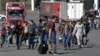 A group of Russians walk after crossing the border at Verkhny Lars between Georgia and Russia, in Georgia, Sept. 27, 2022. After President Vladimir Putin ordered a mobilization to bolster his troops in Ukraine, many Russians are leaving their homes.
