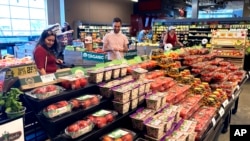 FILE - People shop at a grocery store in Glenview, Ill., Monday, July 4, 2022. 