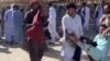 FILE - A screenshot of a video sent to VOA Persian appears to show residents of southeast Iran's Zahedan city carrying a man with bloodstained clothing after police reportedly shot at protesters on Sept. 30, 2022. (UGC)