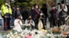 People pray for victims of a deadly accident following Saturday night's Halloween festivities on a street near the scene in Seoul, South Korea, Nov. 1, 2022. 
