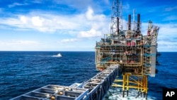FILE - The Sleipner A gas platform, Norway, Oct. 1, 2022, as a Coast Guard ship patrols around the platform. 