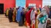 FILE - Somali women and children who left rural areas due to drought receive nutritional assistance at a camp for the internally displaced, on the outskirts of Baidoa, Somalia, Oct. 12, 2022.