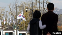 South Korean national flags fly at half-staff at the government complex to mourn the victims of a stampede during Halloween festivities at the popular Itaewon district in Seoul, Oct. 30, 2022. (Yonhap/Reuters)